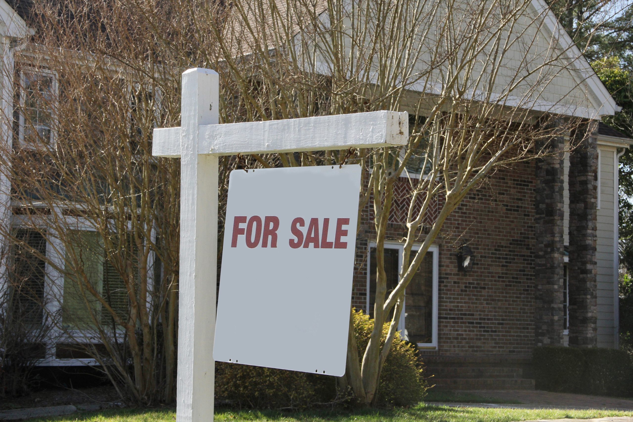 for sale sign in front of home